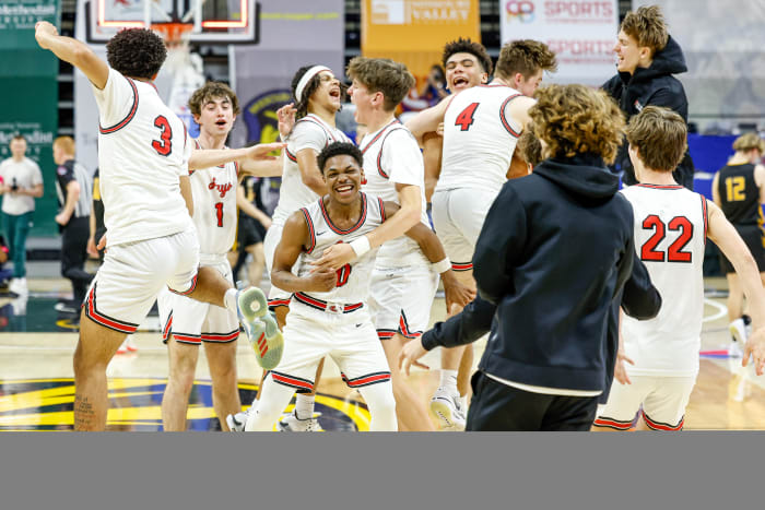 Judah Harris (0) and the Jefferson City boys basketball team celebrate their Missouri Class 5 semifinal win over Vianney